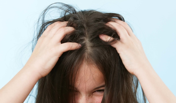 Girl scratching head